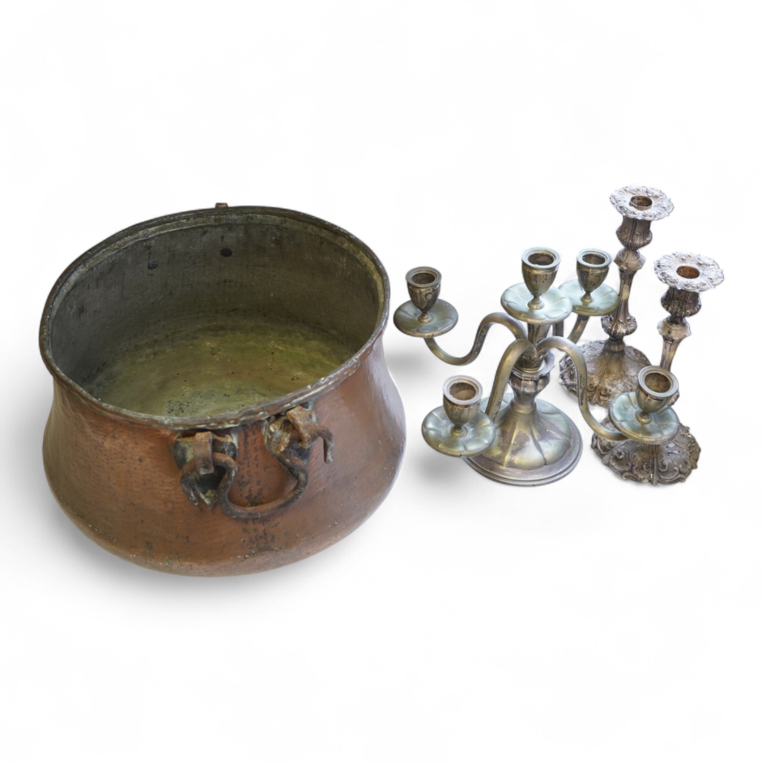 A pair of silver plated candlesticks, a four branch, three light candlestick and a copper cauldron